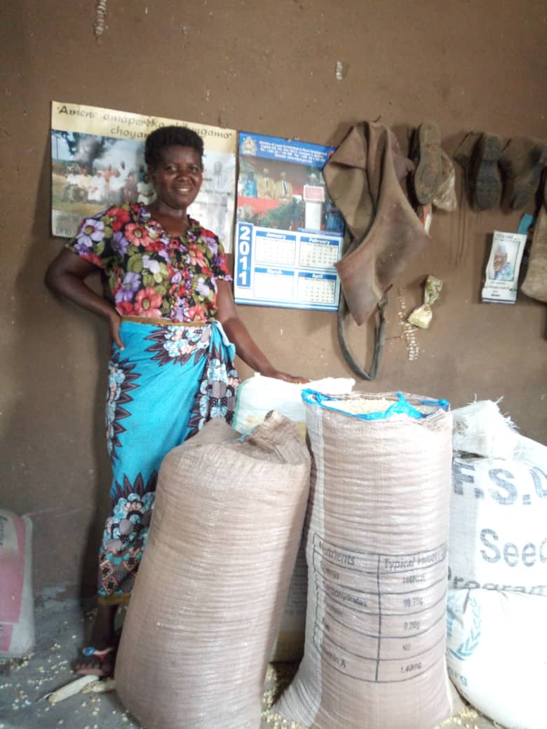 Text Box: 
Mary at home with some of her maize yield.
